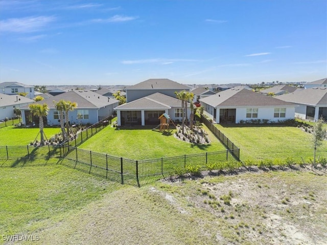 exterior space with a fenced backyard, a residential view, and a front yard