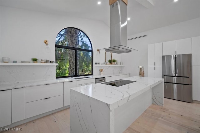 kitchen with white cabinetry, sink, island exhaust hood, light stone counters, and stainless steel appliances