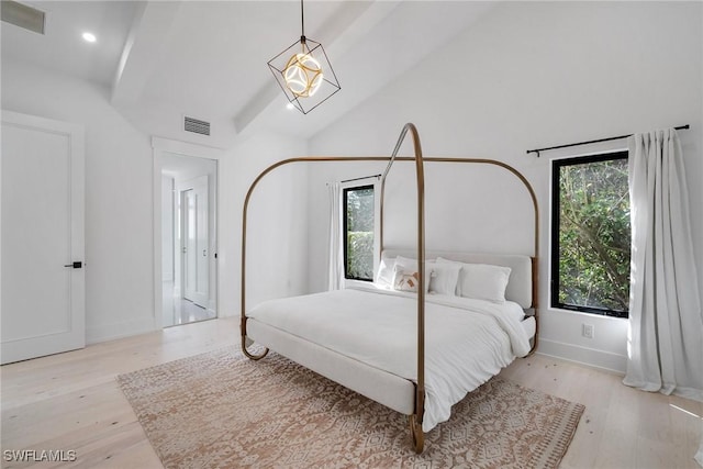 bedroom featuring high vaulted ceiling, light hardwood / wood-style floors, and multiple windows