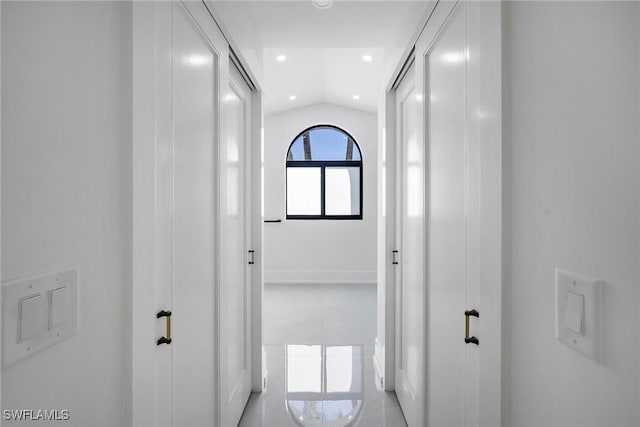 corridor featuring vaulted ceiling