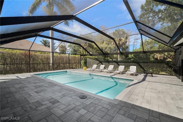 view of swimming pool with a lanai and a patio