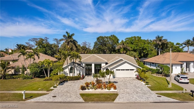 view of front of house with a garage and a front yard