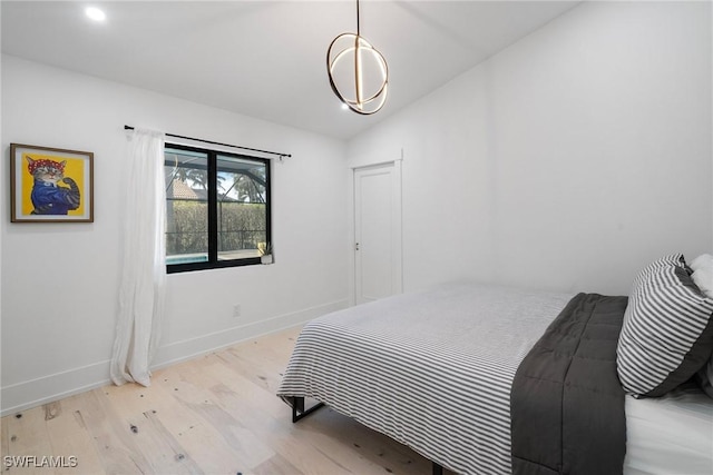 bedroom with light hardwood / wood-style flooring and vaulted ceiling