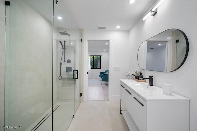 bathroom featuring vanity, tile patterned flooring, and walk in shower