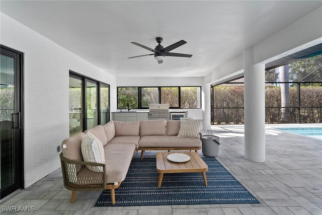 sunroom featuring ceiling fan