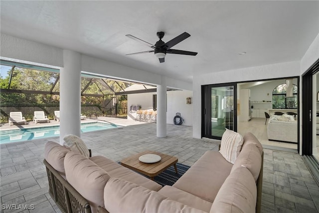 view of patio featuring ceiling fan, an outdoor hangout area, and a fenced in pool