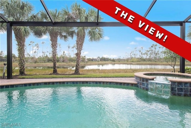 view of swimming pool featuring a water view and an in ground hot tub