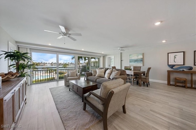 living room with ceiling fan and light wood-type flooring