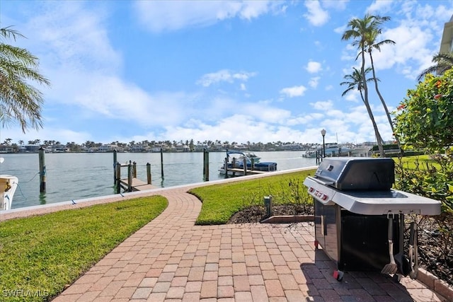 view of patio / terrace featuring a water view, a grill, and a boat dock