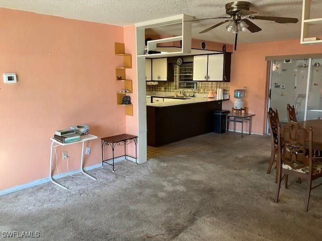 kitchen featuring tasteful backsplash, a textured ceiling, carpet floors, and ceiling fan