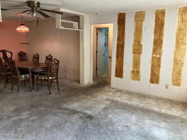 dining room featuring ceiling fan and a textured ceiling