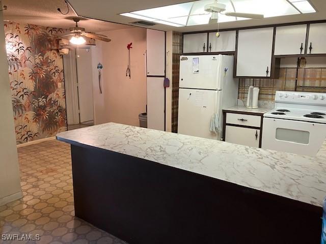 kitchen with white cabinetry, white appliances, and ceiling fan