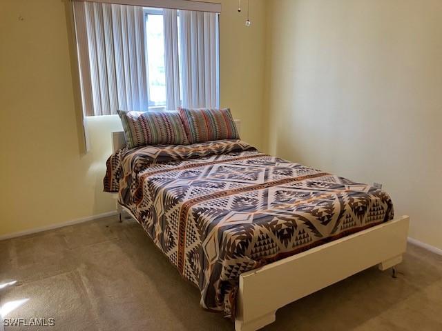 bedroom with light colored carpet