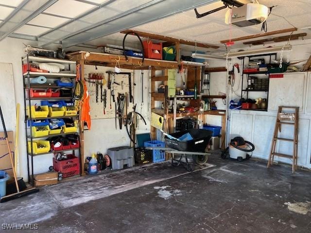 garage featuring a garage door opener and a workshop area