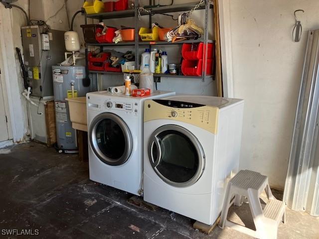 washroom featuring washing machine and dryer and water heater