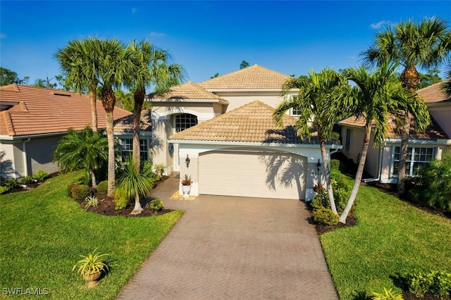 9062 Shadow Glen Way, Fort Myers, FL 33913 - mediterranean / spanish-style house with a tiled roof, stucco siding, a garage, a front lawn, and driveway