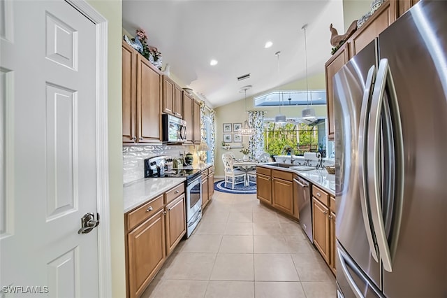 kitchen featuring lofted ceiling, decorative light fixtures, light tile patterned floors, stainless steel appliances, and decorative backsplash