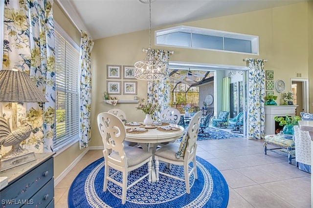 dining area with lofted ceiling, light tile patterned floors, plenty of natural light, and a chandelier