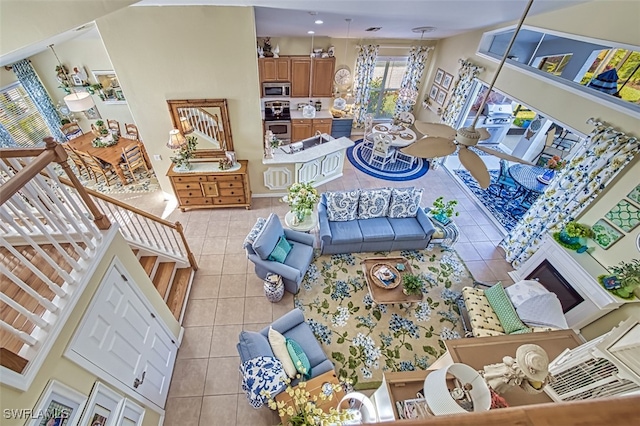 tiled living room featuring ceiling fan