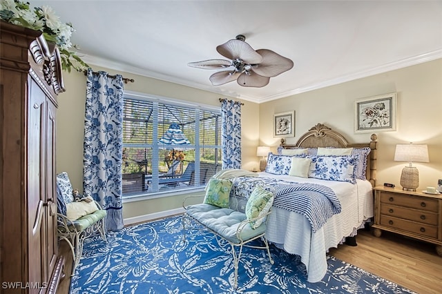 bedroom with crown molding, wood-type flooring, and ceiling fan