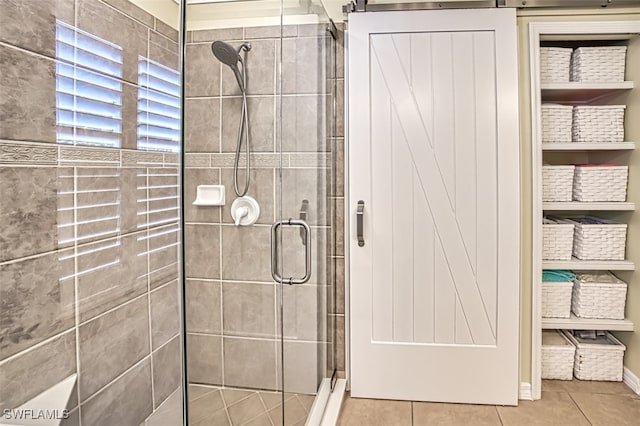 bathroom with tile patterned flooring and a shower with shower door