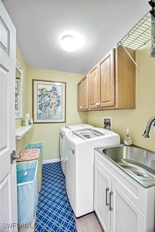 clothes washing area with cabinets, separate washer and dryer, sink, and light tile patterned floors