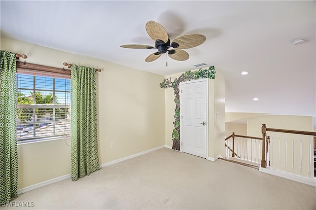 spare room with baseboards, carpet flooring, ceiling fan, and visible vents