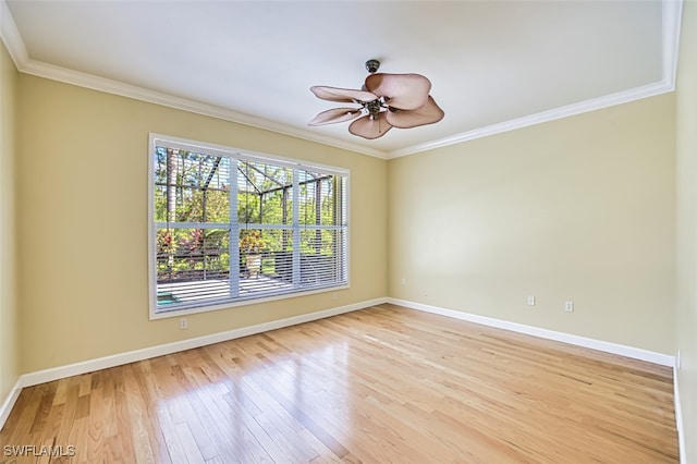 unfurnished room with crown molding, baseboards, ceiling fan, and light wood-style floors