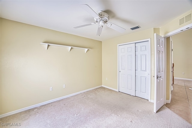 unfurnished bedroom featuring visible vents, carpet, baseboards, and a closet