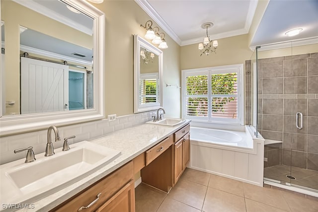 bathroom featuring tile patterned floors, ornamental molding, a sink, and a stall shower