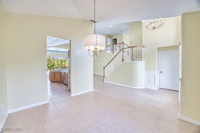 9062 Shadow Glen Way, Fort Myers, FL 33913 - unfurnished room featuring a chandelier, light tile patterned floors, stairway, high vaulted ceiling, and baseboards