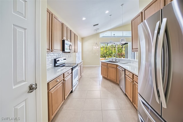 kitchen featuring decorative backsplash, a sink, light countertops, lofted ceiling, and stainless steel appliances