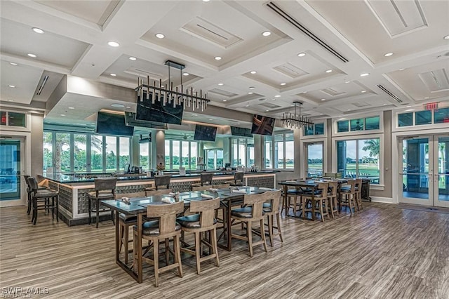 dining room featuring beam ceiling, french doors, recessed lighting, wood finished floors, and coffered ceiling