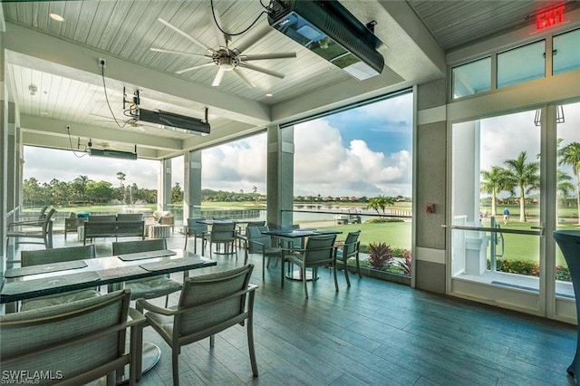 sunroom featuring beam ceiling