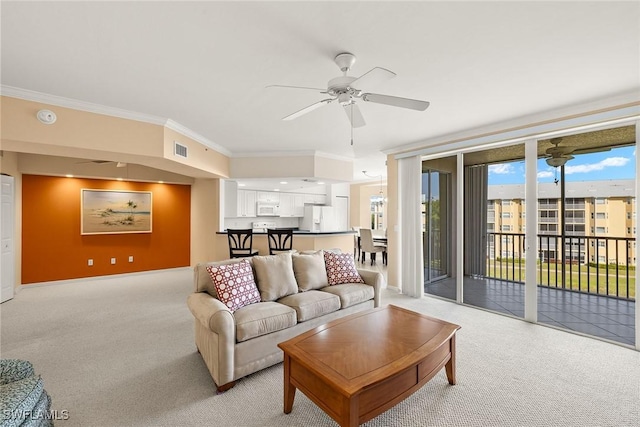 carpeted living room featuring crown molding and ceiling fan