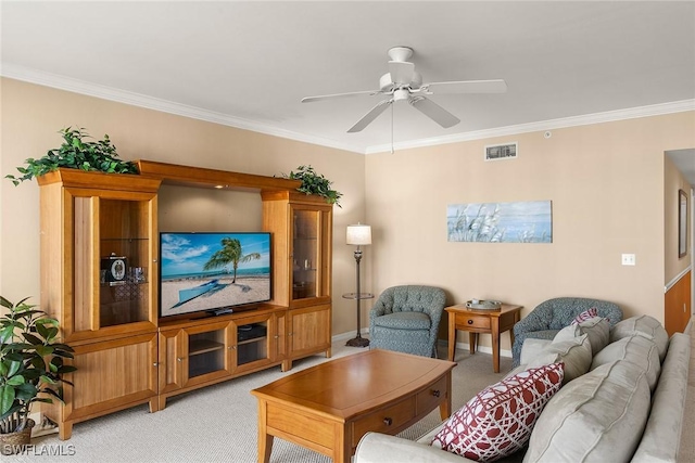 living room with crown molding, ceiling fan, and light carpet