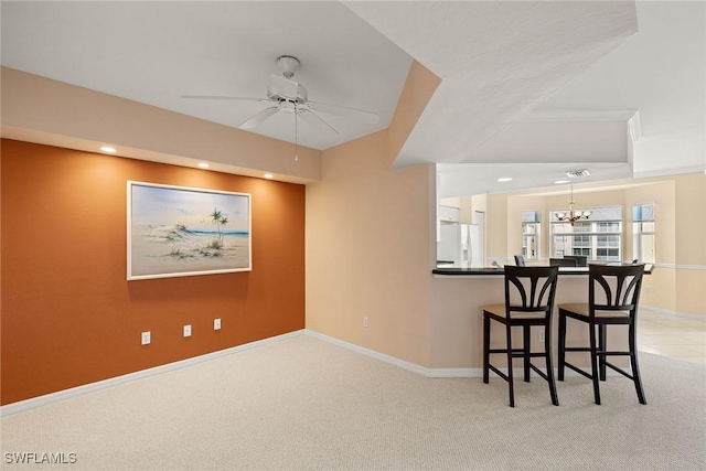 interior space with ceiling fan with notable chandelier