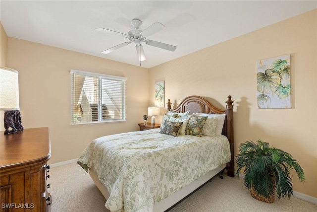 bedroom featuring light colored carpet and ceiling fan