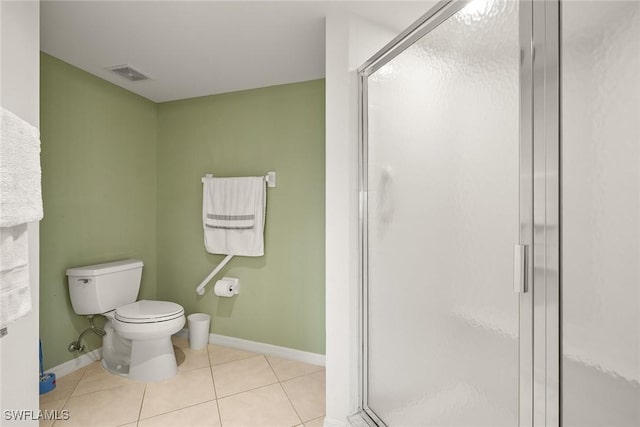 bathroom with tile patterned flooring, an enclosed shower, and toilet