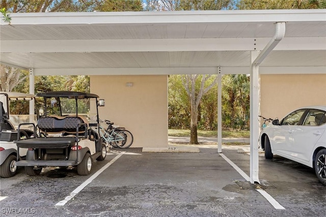 view of parking / parking lot featuring a carport