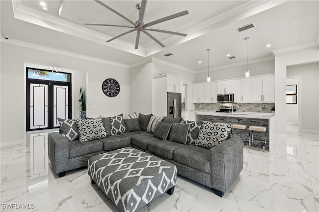 living room featuring french doors, ceiling fan, a tray ceiling, and crown molding