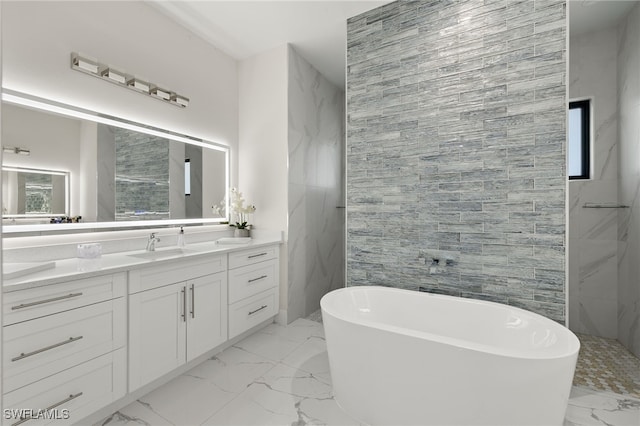 bathroom with vanity, tile walls, and a bathtub