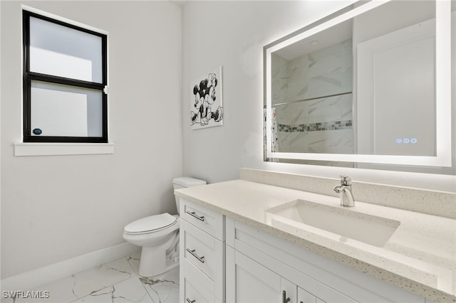 bathroom featuring vanity, toilet, and a shower