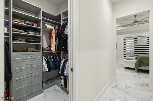 walk in closet featuring ceiling fan