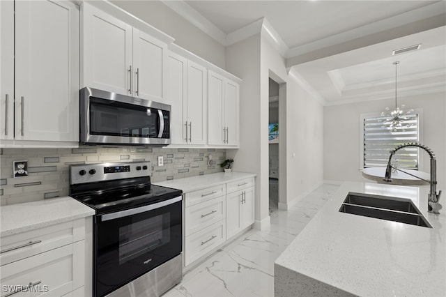 kitchen with sink, stainless steel appliances, ornamental molding, light stone countertops, and white cabinets