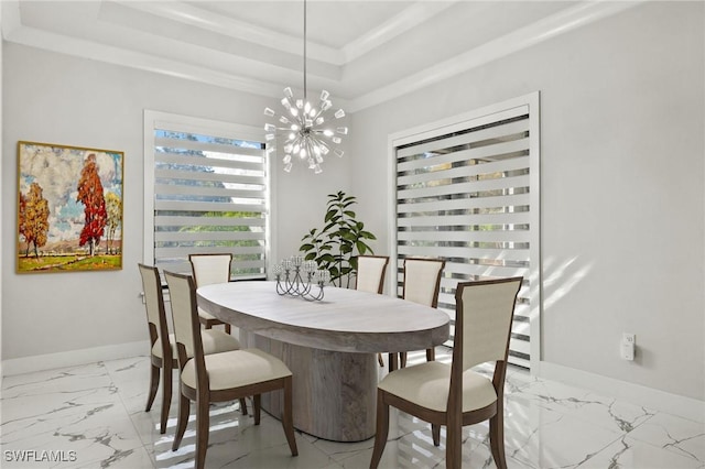 dining room featuring an inviting chandelier, ornamental molding, and a raised ceiling