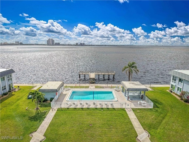 view of swimming pool featuring a water view, a gazebo, and a lawn