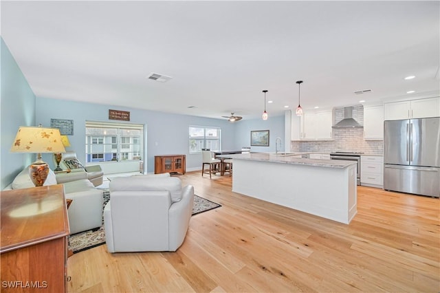 living room with sink and light hardwood / wood-style floors