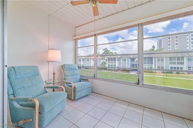 sunroom / solarium with ceiling fan and vaulted ceiling