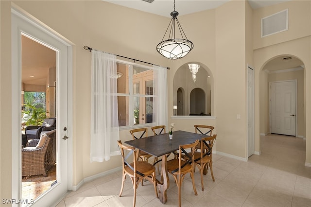 tiled dining room featuring a high ceiling